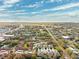 Wide aerial view of the community showcasing its location, nearby roads, and lush surrounding landscape at 1467 Twin Villas Way, Dunedin, FL 34698