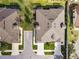 Aerial view of the property showcasing the roof, landscaping, and proximity to the neighborhood at 1467 Twin Villas Way, Dunedin, FL 34698