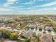 Community aerial view showcasing the neighborhood's layout, mature trees, and nearby amenities at 1467 Twin Villas Way, Dunedin, FL 34698