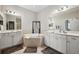 Bright bathroom features double vanity, soaking tub, and neutral tile at 1467 Twin Villas Way, Dunedin, FL 34698