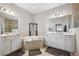 Bright bathroom features double vanity, soaking tub, and neutral tile at 1467 Twin Villas Way, Dunedin, FL 34698