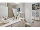 Inviting bathroom showcasing white vanity, decorative art, and plush towels at 1467 Twin Villas Way, Dunedin, FL 34698