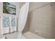 Bathroom features a tiled shower and decorative painting and towels at 1467 Twin Villas Way, Dunedin, FL 34698