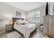 Cozy bedroom with a plush bed, shuttered window, and decorative lamps at 1467 Twin Villas Way, Dunedin, FL 34698