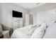 Bright bedroom featuring neutral decor, plush pillows, and direct access to hall at 1467 Twin Villas Way, Dunedin, FL 34698