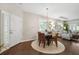 Bright dining area featuring hardwood floors, a chandelier, and comfortable seating at 1467 Twin Villas Way, Dunedin, FL 34698