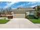 Charming single-story home featuring a two-car garage and well-maintained landscaping at 1467 Twin Villas Way, Dunedin, FL 34698