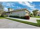 Charming single-story home featuring a well-manicured lawn and attached garage at 1467 Twin Villas Way, Dunedin, FL 34698