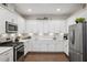 Updated kitchen with white cabinetry, stainless steel appliances, and plenty of storage space at 1467 Twin Villas Way, Dunedin, FL 34698