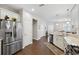 Spacious kitchen features stainless appliances, wood floors, and an open design to the living area at 1467 Twin Villas Way, Dunedin, FL 34698