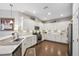 Modern kitchen features white cabinets, stainless steel appliances, and sleek countertops at 1467 Twin Villas Way, Dunedin, FL 34698