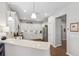 Bright kitchen with white cabinets, modern appliances, and quartz countertops at 1467 Twin Villas Way, Dunedin, FL 34698