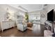 Inviting living room with hardwood floors, tray ceiling, stylish decor and abundant natural light at 1467 Twin Villas Way, Dunedin, FL 34698