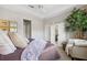 Comfortable main bedroom with a tray ceiling, soft carpet, and a decorative tree at 1467 Twin Villas Way, Dunedin, FL 34698
