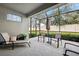 Relaxing screened-in patio with comfortable seating, shade, and lush landscaping at 1467 Twin Villas Way, Dunedin, FL 34698