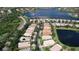 An aerial view of a well-maintained residential community with lush landscaping, several lakes, and neatly arranged homes at 16232 Amethyst Key Dr, Wimauma, FL 33598