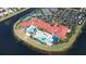 An aerial view showing a pool, the tennis courts, and a lake enhancing the community's appeal at 16232 Amethyst Key Dr, Wimauma, FL 33598
