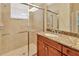 Bathroom featuring granite counters, a wood vanity, and a glass door shower with tile surround at 16232 Amethyst Key Dr, Wimauma, FL 33598