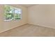Empty bedroom with neutral walls, carpet flooring, and a window letting in natural light at 16232 Amethyst Key Dr, Wimauma, FL 33598
