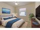 Well-lit bedroom featuring a comfortable bed, elegant decor, and a ceiling fan for added comfort at 16232 Amethyst Key Dr, Wimauma, FL 33598