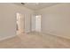 Unfurnished bedroom featuring neutral walls, carpeting, and two entry doors at 16232 Amethyst Key Dr, Wimauma, FL 33598