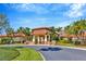 Elegant clubhouse entrance with manicured landscaping and a welcoming porte-cochère at 16232 Amethyst Key Dr, Wimauma, FL 33598