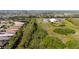 Aerial image shows a community with lush greenery next to highway. Dome shaped building visible at 16232 Amethyst Key Dr, Wimauma, FL 33598