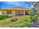 Rear view of the house showing the screened lanai and well-maintained lawn at 16232 Amethyst Key Dr, Wimauma, FL 33598
