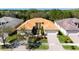 Charming home with a tile roof, double-door entrance, well-maintained lawn, and brick driveway at 16232 Amethyst Key Dr, Wimauma, FL 33598