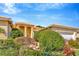 Beautiful home exterior with lush landscaping, a three-car garage and a tile roof at 16232 Amethyst Key Dr, Wimauma, FL 33598