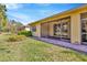 Exterior of the house showcasing the lanai and the lush lawn and landscaping at 16232 Amethyst Key Dr, Wimauma, FL 33598