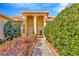 Home with covered entry, decorative plants, and brick paver walkway at 16232 Amethyst Key Dr, Wimauma, FL 33598