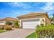 Detached garage with brick-paved driveway and manicured landscaping at 16232 Amethyst Key Dr, Wimauma, FL 33598