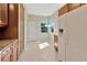 Bright kitchen showcases tiled floors, white appliances, and natural light from adjacent windows at 16232 Amethyst Key Dr, Wimauma, FL 33598