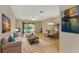 Bright, open living area with tile floors, comfortable seating, and a view of the outdoor patio at 16232 Amethyst Key Dr, Wimauma, FL 33598
