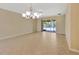 Open-concept living space with tile floors, a ceiling fan, and access to the screened-in patio at 16232 Amethyst Key Dr, Wimauma, FL 33598