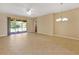 Spacious living area with tile floors and access to the screened outdoor patio at 16232 Amethyst Key Dr, Wimauma, FL 33598