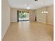 Bright living room features tile floors, sliding glass doors, and a ceiling fan at 16232 Amethyst Key Dr, Wimauma, FL 33598