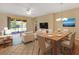 Bright, open living area with tile floors, comfortable seating, and a view of the outdoor patio at 16232 Amethyst Key Dr, Wimauma, FL 33598