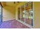 Enclosed patio featuring brick flooring and a large sliding glass door to the backyard at 16232 Amethyst Key Dr, Wimauma, FL 33598