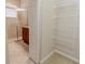 This walk-in closet has convenient wire shelving with bathroom featuring tiled walk-in shower in the background at 16232 Amethyst Key Dr, Wimauma, FL 33598
