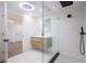 Bathroom featuring wood vanity with white countertop and frameless glass shower at 163 Dolphin E Dr, Oldsmar, FL 34677