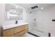 Modern bathroom with rain head shower, floating wood vanity and large mirror at 163 Dolphin E Dr, Oldsmar, FL 34677
