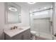 Bright bathroom featuring glass-enclosed shower, grey vanity and modern lighting at 163 Dolphin E Dr, Oldsmar, FL 34677
