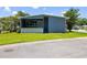 Charming single-story home with a covered front porch and well-maintained lawn at 163 Dolphin E Dr, Oldsmar, FL 34677