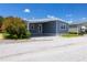 Single-story home with carport, tidy landscaping, and desirable curb appeal at 163 Dolphin E Dr, Oldsmar, FL 34677