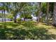 Community lawn with mature trees providing lots of shade and curb appeal at 163 Dolphin E Dr, Oldsmar, FL 34677