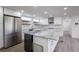 Modern kitchen with white cabinets, stainless appliances, and stylish gray countertops at 163 Dolphin E Dr, Oldsmar, FL 34677