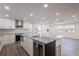 Bright, updated kitchen with white cabinets, stainless appliances, and a large center island at 163 Dolphin E Dr, Oldsmar, FL 34677