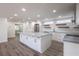 Spacious kitchen featuring white cabinets, stainless steel appliances, and stylish gray countertops at 163 Dolphin E Dr, Oldsmar, FL 34677